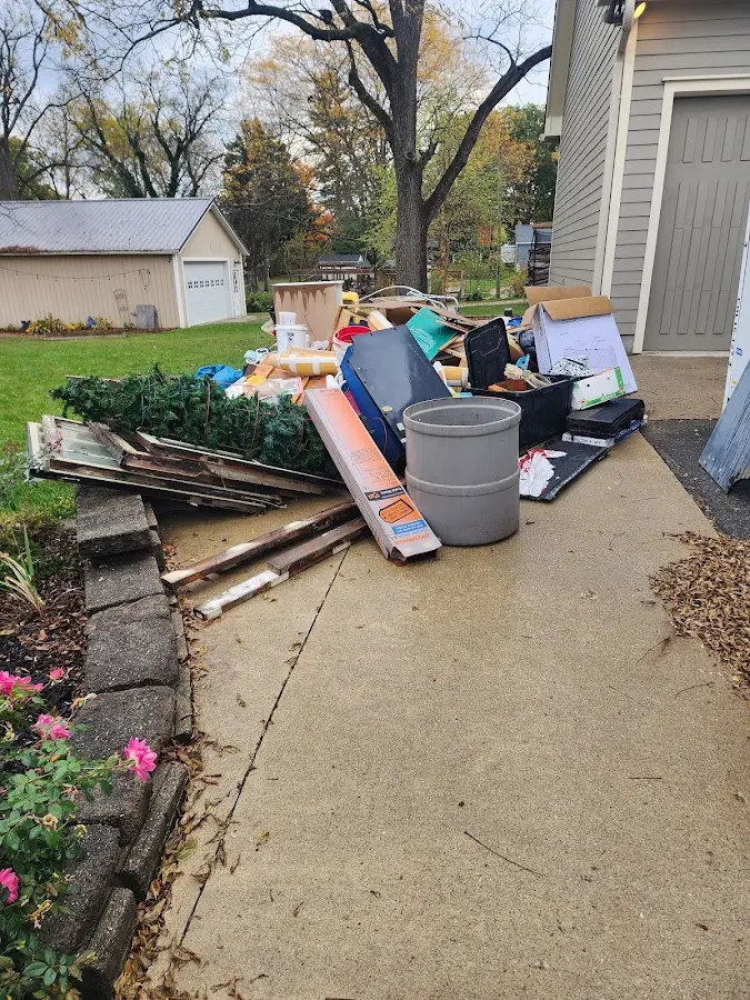 Dumpster being loaded with debris for Roofing Dumpster Rental in Highland Village